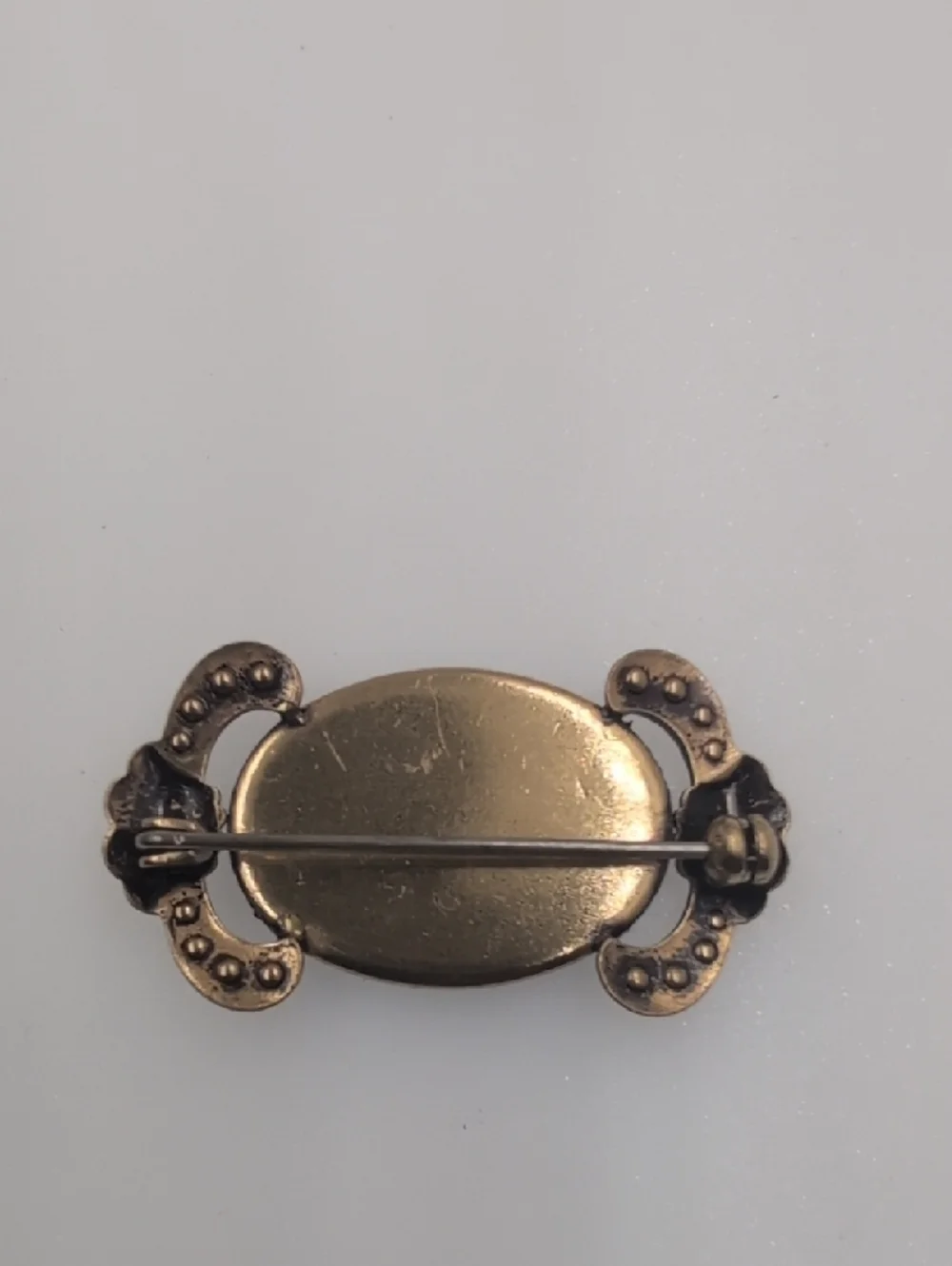 Gold-Tone Black Oval Cabochon Brooch with Crystal Accents